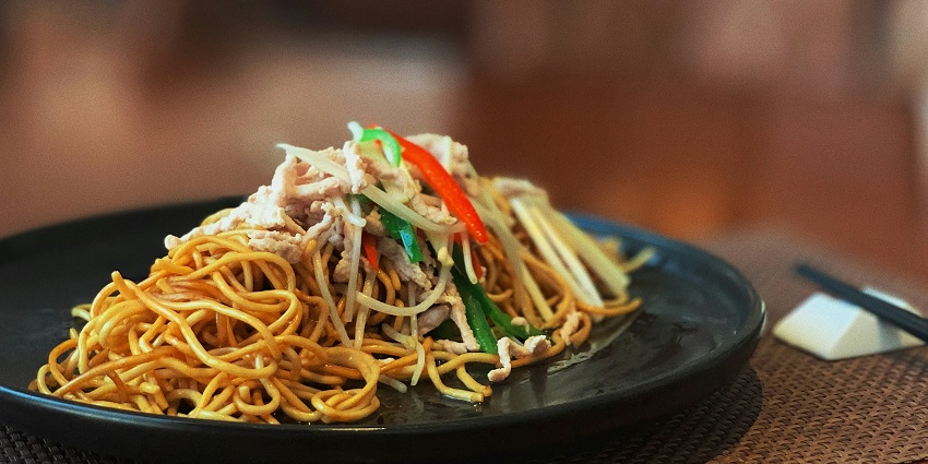 A plate of delicious noodles served with vegetables and sauce at Nagameez.
