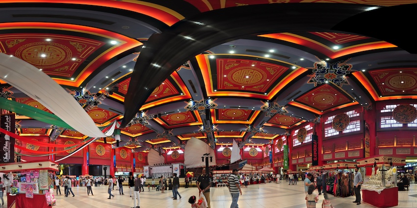 A panoramic view of a themed court, featuring elaborate architectural details and shops, one of the best markets in Dubai.