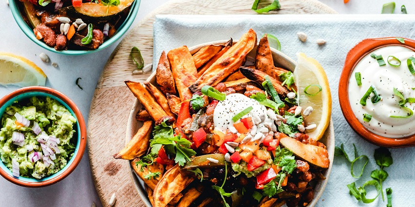 Top view of crispy fries served with tangy salsa at the restaurant.