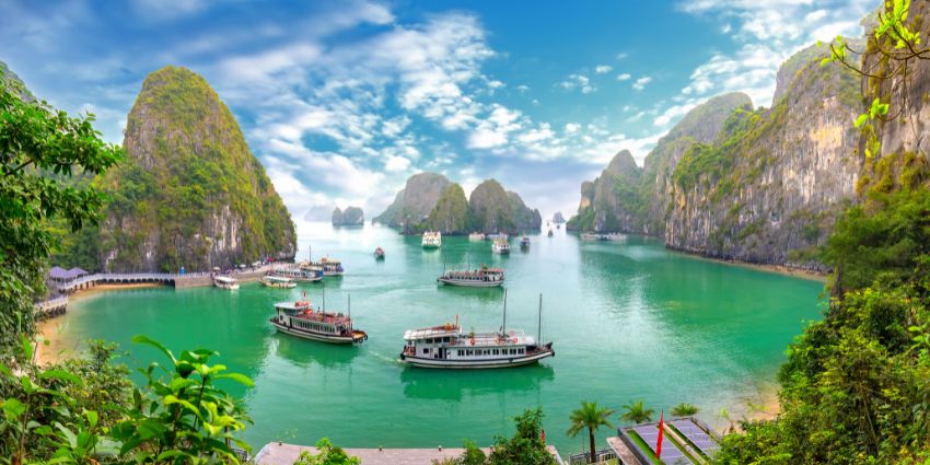 A stunning view of Ha Long Bay featuring turquoise-blue waters and lush greenery.