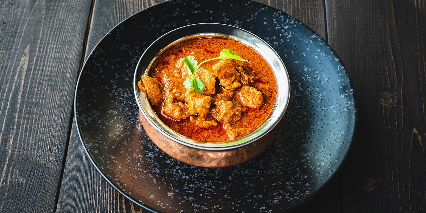 A bowl of butter Chicken served at Paradise Palace Restaurant, one of the top restaurants in Tezpur.
