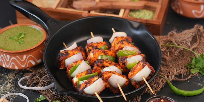 Grilled paneer tikka pieces served with chutney at Pirates Of Grill, one of the best restaurants in Guwahati for couples.
