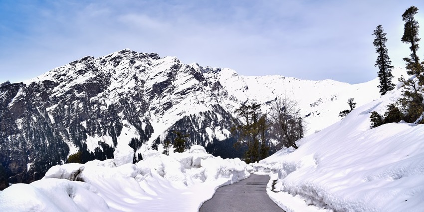 Scenic mountain road winding through rocky terrain en route to Rohtang Pass