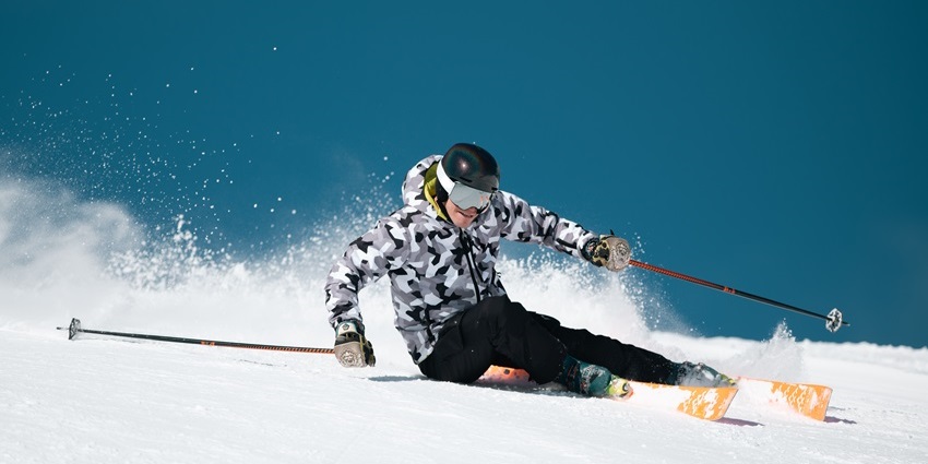 An image of a skier carving down challenging slopes at a snow mountain