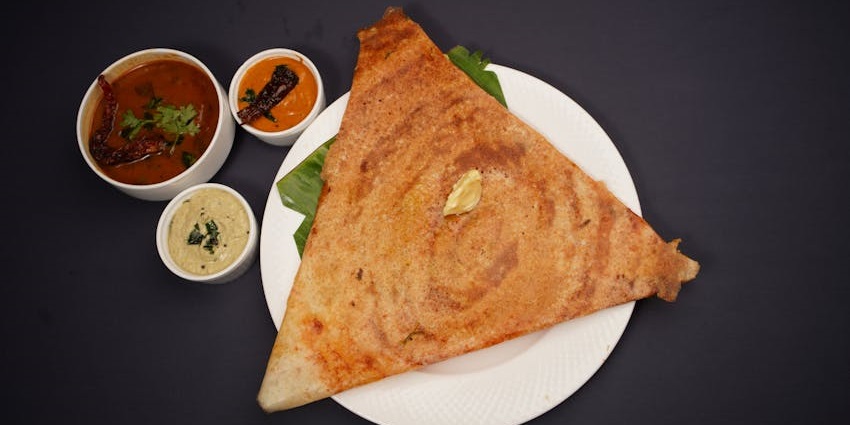 Dosa with sambhar and chutney served at South Coast Restaurant, a must-try at restaurants on Zoo Road Guwahati.