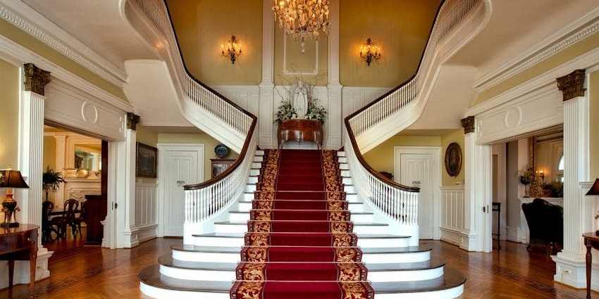 Red and brown floral stair carpet at The Leela Palace, Chennai – elegant hotel interior.
