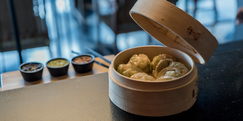 Steamed momos served on a plate at The Socialite restaurant.

