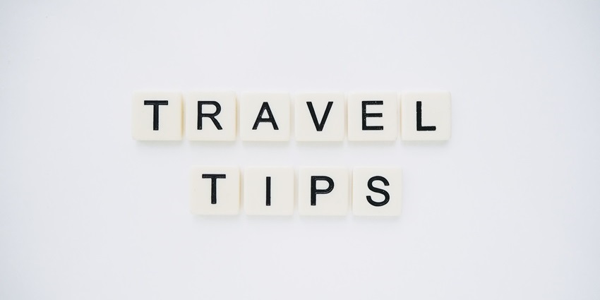 Scrabble tiles arranged to spell 'Travel Tips' on a clean white background