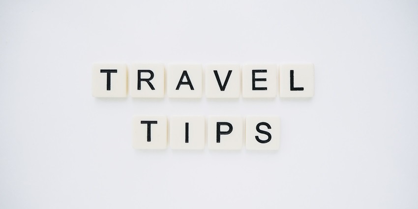 Scrabble tiles arranged to spell 'Travel Tips' on a clean white background