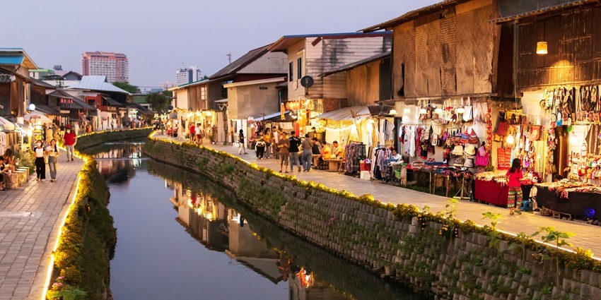 People walking through the streets of the Old City at night in Chiang Mai.