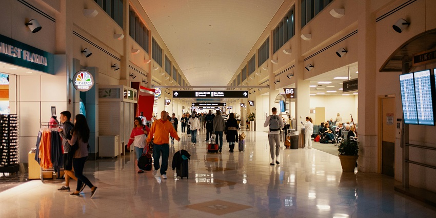 People waiting with luggage and walking through the terminal – airports in Kashmir.
